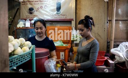 Two Sisters Working at Coffee Tea and Beverage Shop at Phsar Toul Tom Poung the Bazaar Russian Market in  Phnom Penh, Cambodia South East Asia Stock Photo