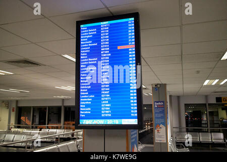 airport flight information screen in departure lounge of belfast international airport Stock Photo