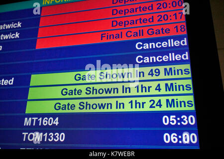 airport flight information screen showing last calls cancelled flights and gate information Stock Photo