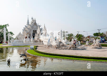 The bridge of the 'Cycle of Rebirth' leading to the Gate of Heaven and into the Ubosot at Wat Rong Khun (White Temple). Chiang Rai Province, Thailand Stock Photo