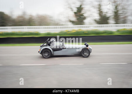 Fast car on racetrack at Goodwood with motion blur Stock Photo