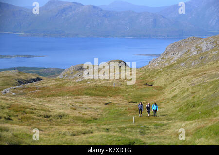 Three Female Fell Walkers on the Western Ridge of the Scottish Mountain Corbett Fraochaidh with Loch Linnhe in the Background. Stock Photo