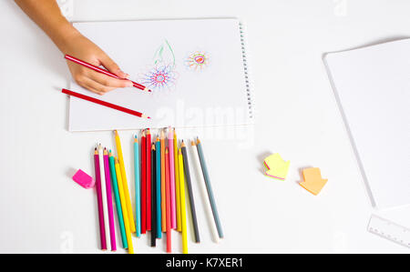 Top view of baby's hand drawing with green pencil on white paper with the  set of colour pencils. Kids painting concept. Copy space for text. Mockup  Stock Photo - Alamy