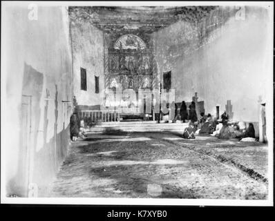 Interior of the old church during early morning mass at the Acoma Pueblo, New Mexico, 1886 (CHS 4541) Stock Photo