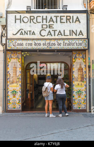 Horchateria, two young women tourists to look into the renowned Horchateria de Santa Catalina in the historical old town quarter of Valencia, Spain. Stock Photo