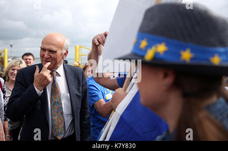 Liberal Democrat leader Sir Vince Cable (left) speaks with pro-EU Liberal Democrat supporters during the second day of the Liberal Democrats Autumn Conference at the Bournemouth International Centre. Stock Photo