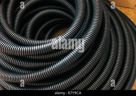 black ribbed plastic hose for electrical installations Stock Photo