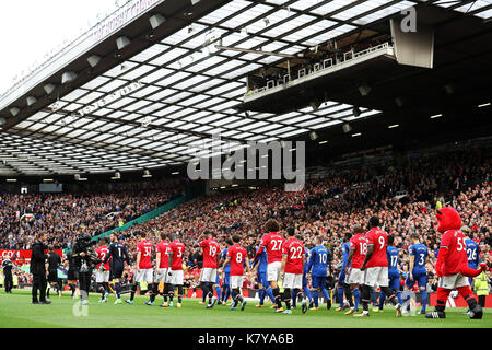 Manchester United and Everton players walk onto the pitch before the Premier League match at Old Trafford, Manchester. Stock Photo