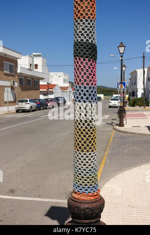 Yarn bombing, knitted sleeve around a lamppost in village, Spain. Stock Photo