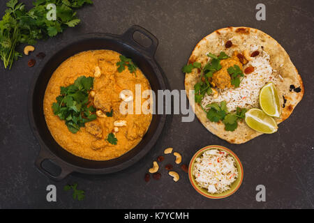 Mutton Korma, Indian curry meal with  nuts, rice and peshwari naan, top view, blank space Stock Photo