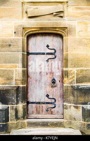 Stripped Paint Gives This Gothic Cathedral Door a Pink Cast. Stock Photo