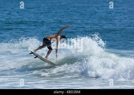 SEA GIRT, NEW JERSEY - September 15, 2017: Surfers enjoy a warm, sunny day as Summer comes to a close Stock Photo