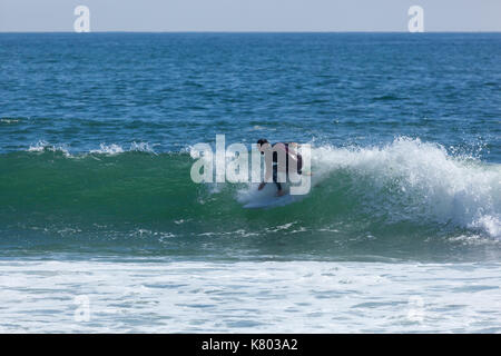 SEA GIRT, NEW JERSEY - September 15, 2017: Surfers enjoy a warm, sunny day as Summer comes to a close Stock Photo