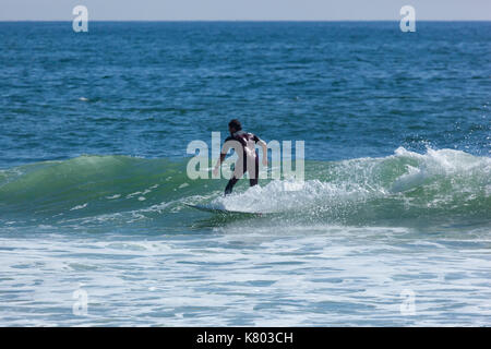 SEA GIRT, NEW JERSEY - September 15, 2017: Surfers enjoy a warm, sunny day as Summer comes to a close Stock Photo