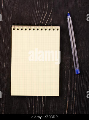 blank notebook with pen on wooden table, business concept Stock Photo