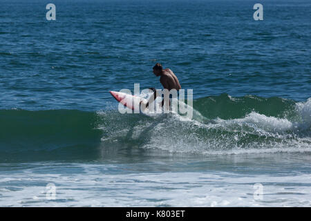 SEA GIRT, NEW JERSEY - September 15, 2017: Surfers enjoy a warm, sunny day as Summer comes to a close Stock Photo