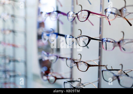 Many different glasses displayed at optician in store Stock Photo