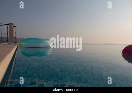 Lie Low and floating rings in swimming pool Stock Photo