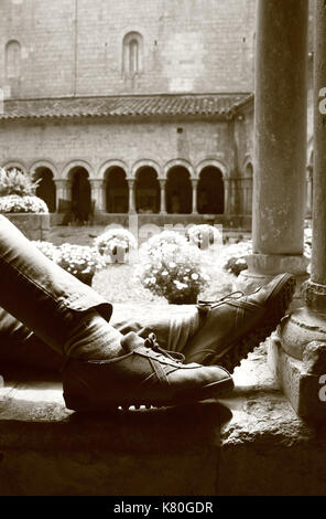 Feet of person sitting in cloister of Girona Cathedral, Catalonia, Spain Stock Photo