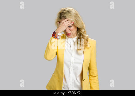 Exhausted blond woman having headache. Stock Photo