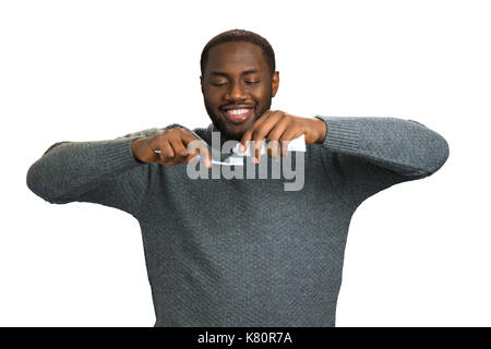Black man applying toothpaste on a toothbrush. Stock Photo
