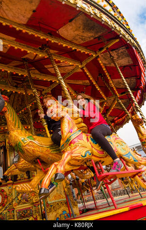 Aberystwyth Wales UK, Sunday  17 September 2017  A young woman  enjoying a ride on the  Noyce & Sons famous ornate 'Golden Gallopers' carousel fairground attraction during a weekend of events to celebrate 95 years of the Great Western on the Vale of Rheidol narrow gauge railway in Aberystwyth  photo © Keith Morris / Alamy Live News Stock Photo
