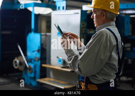 Senior Technician with Digital Tablet Stock Photo