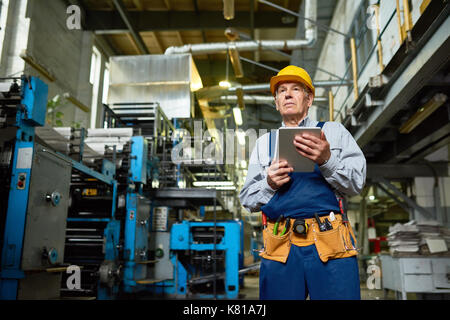 Senior Engineer Wrapped up in Work Stock Photo