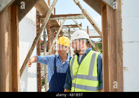 Construction Workers Analyzing Work Results Stock Photo