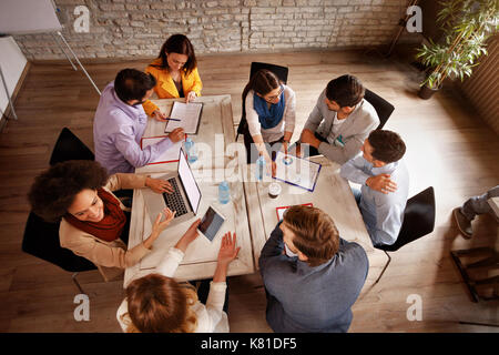 Group of young employees working in office, top view Stock Photo
