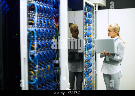 Beautiful Young Woman Working with Servers Stock Photo