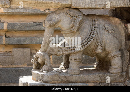 Mysore, India - October 27, 2013: Closeup of brown stone elephant statue supporting part of the Trikuta shrine at Chennakesava Temple in Somanathpur. Stock Photo