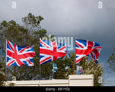 Union Jack Flags blowing in the wind. National flag of Great Britain Stock Photo