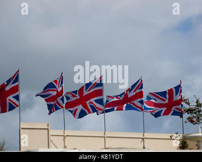 Union Jack Flags blowing in the wind. National flag of Great Britain Stock Photo