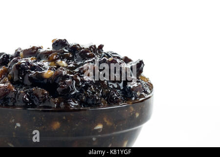 macro shot of homemade christmas traditional mincemeat in a glass bowl on a white isolated background Stock Photo