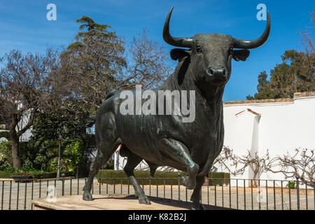 Ronda, Spain - March 7, 2017: Bull statue in front of the bullfighting arena in Ronda, Andalusia, Spain. Stock Photo