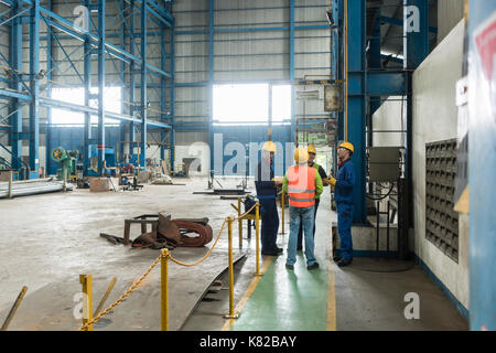 Group of four workers talking during break Stock Photo