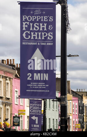 LONDON, UK - AUGUST 12, 2017:  Advertising Banner for Poppies Fish and Chips Shop in Camden Stock Photo