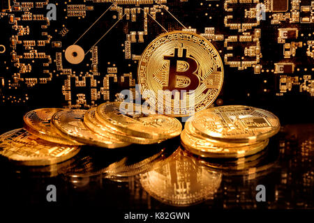 View of a stack of bitcoins on background of electronic schemes - blockchain and cyber currency concept Stock Photo