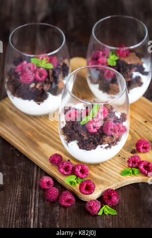 Raspberry and chocolate trifle desert on wooden background Stock Photo