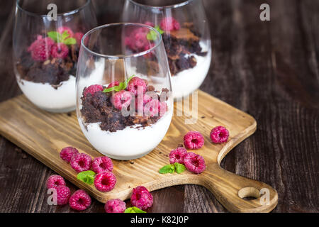 Raspberry and chocolate trifle desert on wooden background Stock Photo