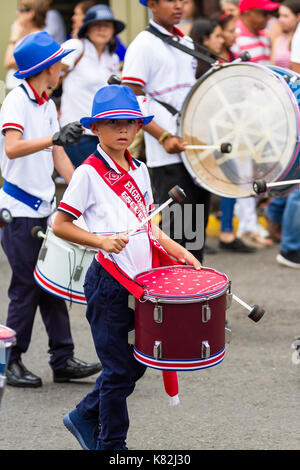 Tilaran, Costa Rica - September 15 : School children marching in the town square playing percussion instruments for the independence day parade. Septe Stock Photo