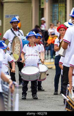 Tilaran, Costa Rica - September 15 : School children marching in the town square playing percussion instruments for the independence day parade. Septe Stock Photo