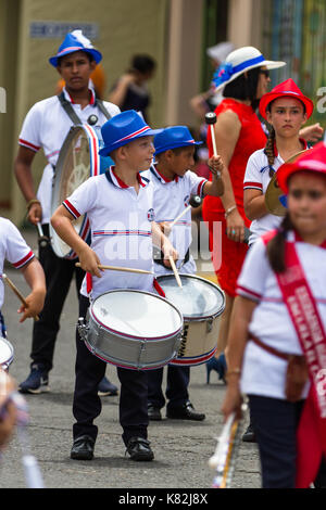 Tilaran, Costa Rica - September 15 : School children marching in the town square playing percussion instruments for the independence day parade. Septe Stock Photo