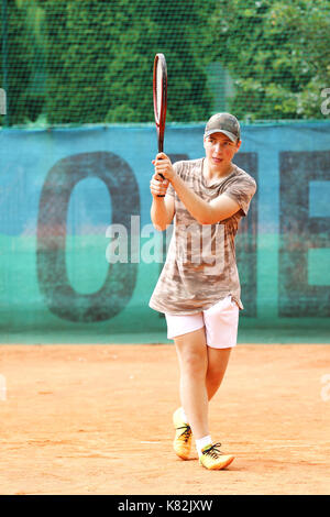 Young boy play backhand return od court Stock Photo