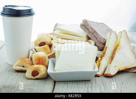 breads and coffee cups on wooden floor. Stock Photo