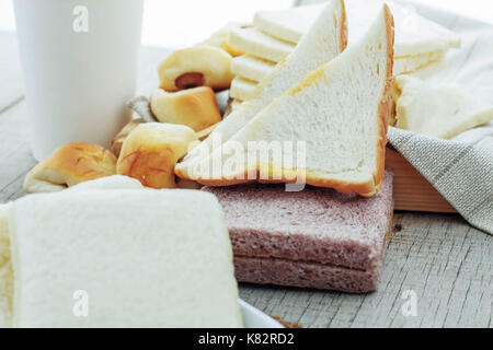 Many breads and coffee cups on wooden floor. Stock Photo