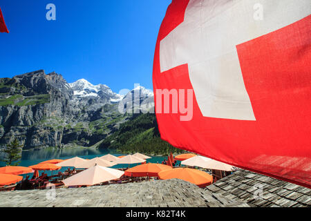 Tourists relaxing at Lake  Oeschinensee Bernese Oberland Kandersteg Canton of Bern Switzerland Europe Stock Photo
