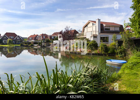 Traditional houses around a pond in Krimpen aan den IJssel in the Netherlands Stock Photo