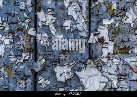 Old Urban Billboard With Torn Peeled Poster Abstract Horizontal Background. Outdoor Bulletin Board Or Plywood Panel With Worn Advertising Message Stock Photo